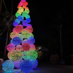 Giant lighted fiberglass orb tree centerpiece illuminated at night